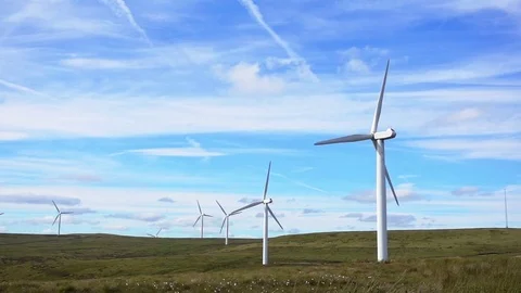 Slow Motion Wind Turbines against sunny blue sky Stock Footage 77652332