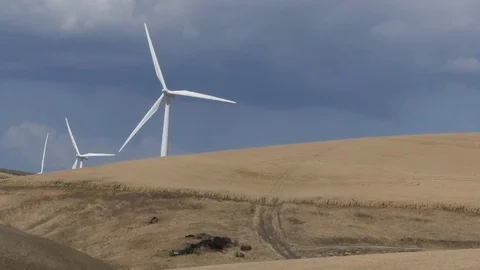 Slow motion windmill turning with grey sky as background Stock Footage 112047813