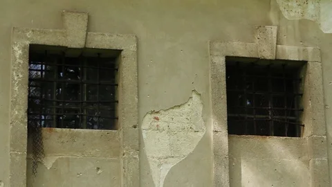 Slow motion window with lattice of an old in a stone house conceptual blockhouse Stock Footage 98154264