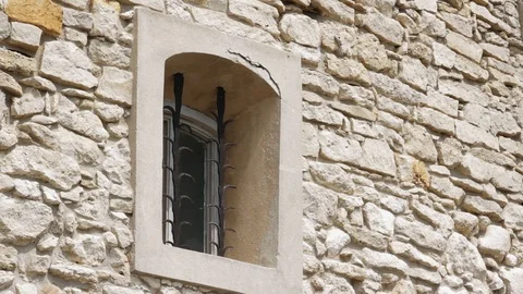 Slow motion the window of an old in a stone house conceptual blockhouse cold Stock Footage 98153833