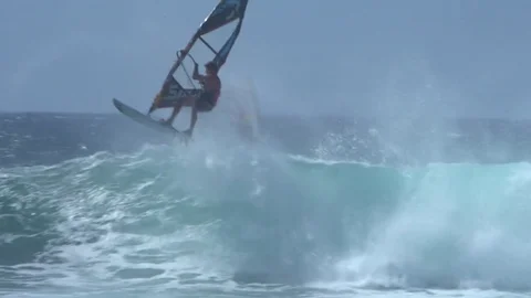 Slow motion windsurfer flips on wave and makes it, extreme sport Stock Footage 77611035