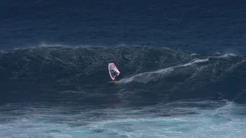 Slow motion of windsurfer getting big air on giant wave in Hawaii, extreme sport Stock Footage 77611106