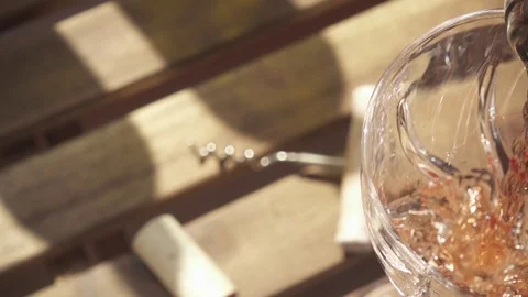 Slow motion the wine from the bottle neck flows into the glass on the table Stock Footage 88916161