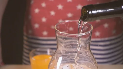 Slow motion wine is poured into a carafe with water and ice Video stock 87946719