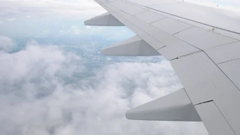 Slow motion, Wing of an airplane flying above the cloud, Full HD Stock Footage 90814067