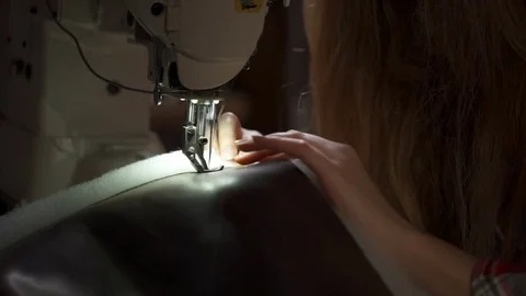 Slow motion of woman hand stitching leather product with vintage sewing machine Stock Footage