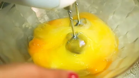 Slow motion of woman hand while preparing homemade food with egg beater,lockdown Stock Footage 139294058