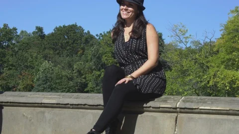 Slow motion of woman smiling while sitting in Central Park, NY Stock Footage 85575504