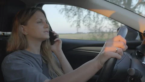Slow motion, woman using mobile smart phone while driving a car Stock Footage 278407577