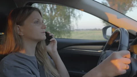 Slow motion, woman using mobile smart phone while driving car Stock Footage 278407597