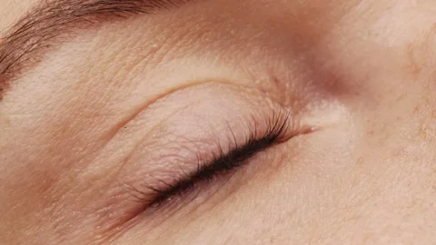 SLOW MOTION: A woman's eye with long black eyelashes after lamination. Closeu Stock Footage 194402293