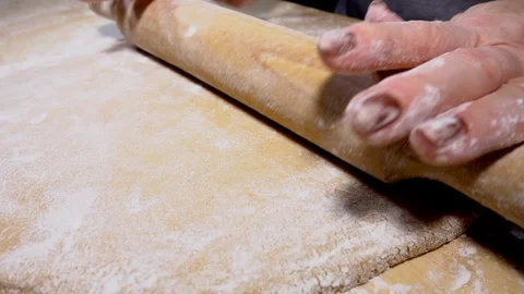 Slow motion – Woman’s hands using a rolling pin on gingerbread dough. Stock-Footage 100179620