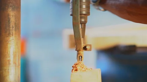 Slow motion wood drill machine working on blurred bright background Stock Footage 100339211