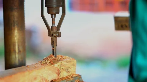 Slow motion wood drill machine working on blurred bright background Video stock 100340214