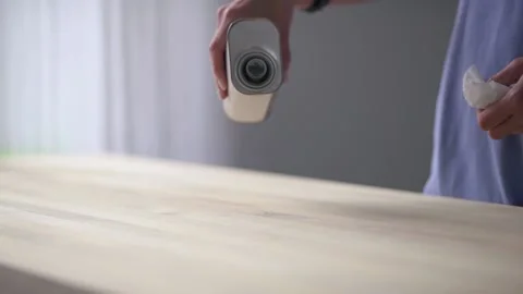 Slow motion. Wood work . The master pours oil on a wooden table. Stock Footage 133061607