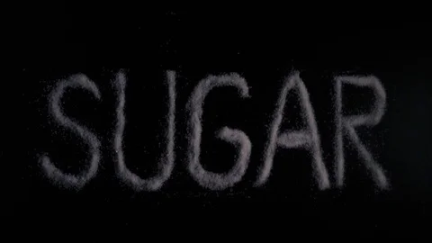 Slow motion word sugar written on a black background Stock Footage 71976857