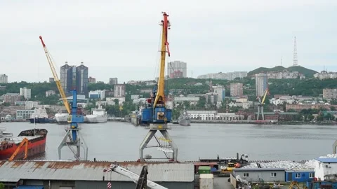 Slow motion of the work of crane lifting and carrying a load in ship terminal Stock Footage 220641785