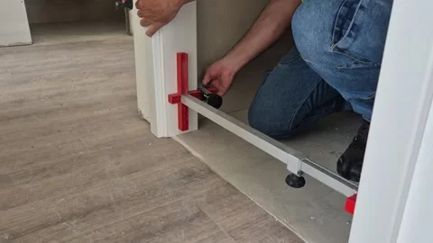 Slow motion of worker aligning door frame with brace tool Stock Footage 337847589