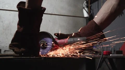 Slow motion. Worker cuts metal with a grinding machine Stock Footage 159744574