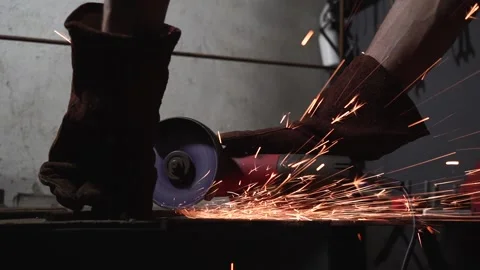 Slow motion. Worker cuts metal with a grinding machine Stock Footage 159744575
