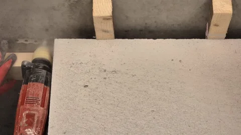 Slow motion of worker drilling into concrete for steel strapping installation Stock-Footage 333588469