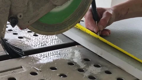 Slow motion of worker measuring and marking a tile slab for precise cutting Stock Footage 333588474