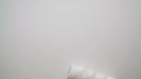 Slow Motion of Worker Painter Paints the Wall with a Roller Stock Footage 125714106