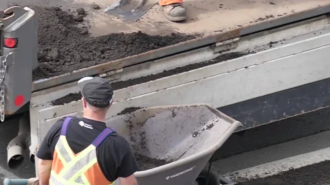 Slow motion of worker pouring waste soil on truck Stock Footage 133617833