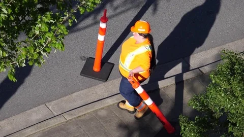 Slow motion of worker putting some barricade signs on road Stock Footage 76134970