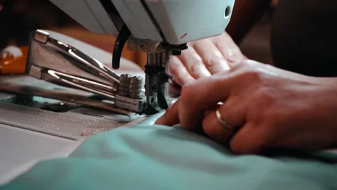 Slow motion worker sewing oven mitts Stock Footage 135269736