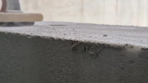Slow motion of worker using hand rasp on concrete block with falling dust Vidéo 333588536