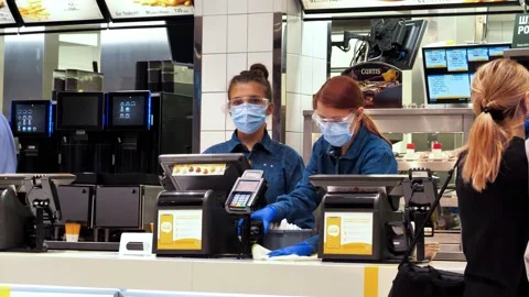 Slow Motion Workers in masks inside McDonalds fast food restaurant in Kyiv city Video stock 135753356