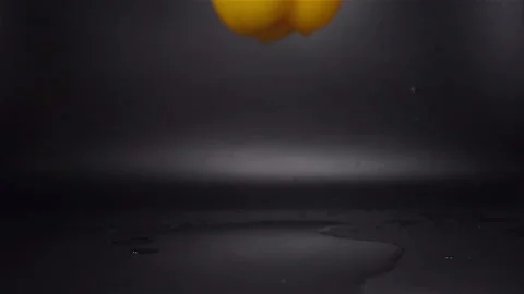 Slow Motion of Yellow Pepper Falling in Water with Splash Stock Footage 104726828