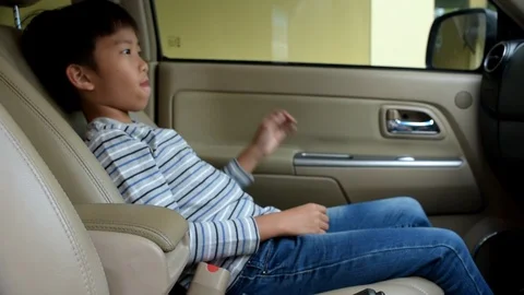 Slow motion young Asian boy prepare seatbelt in a car  Stock Footage 86636660