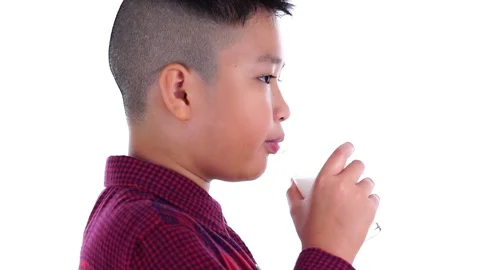 Slow motion young Asian boy drink milk from a glass Stock Footage 89753718