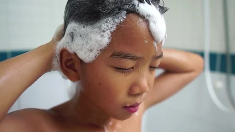 Slow motion young Asian boy wash hair with shampoo 스톡 동영상 89753850