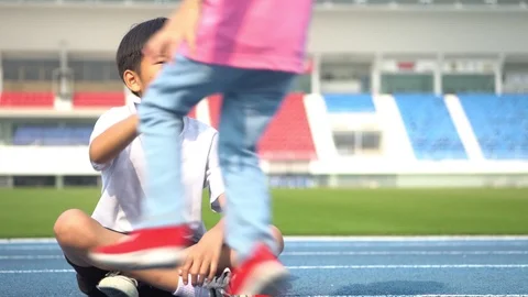 Slow motion Young Asian boy get a bootle of water from little girl Stock Footage 124367131