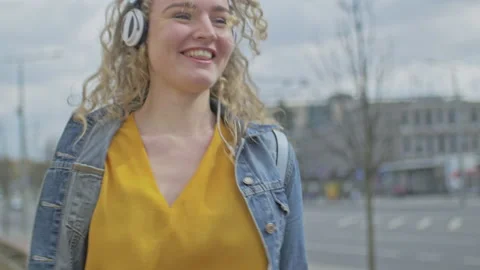 Slow motion of young blonde dancing and spinning to music rhythm Stock Footage 143051881