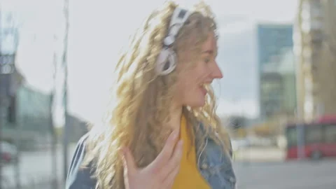 Slow motion of young blonde dancing and spinning to music rhythm Stock Footage 143054619