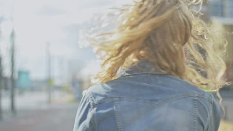 Slow motion of young blonde dancing and spinning to music rhythm Stock Footage 143055179