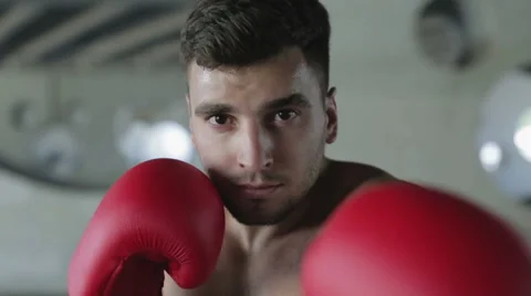 Slow motion. Young boxer with a confident eyes is waiting the fight. Stock Footage 68758132