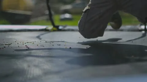 (Slow Motion) A young boy plays on a trampoline Stock Footage 22051420