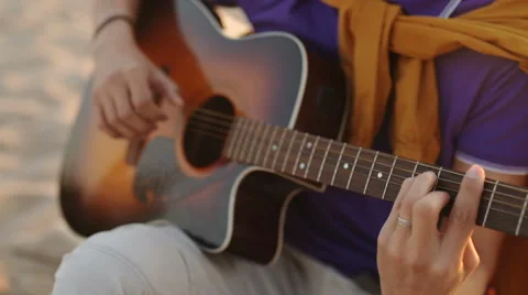 SLOW MOTION. young boy plays guitar at sunset Stock Footage 63499813