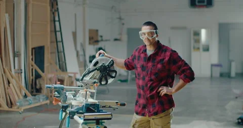 Slow motion of a young carpenter standing in the carpentry shop while looking at Stock Footage 199617219
