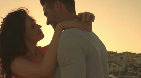 Slow motion young couple dancing by marina in sunset. Stock Footage 43668453