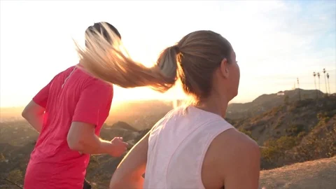 Slow motion: Young couple jogging on top of Hollywood hills in Los Angeles Vidéo gratuite 112288065