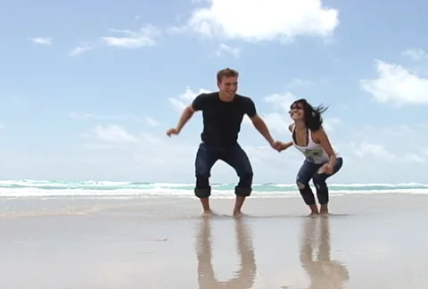 Slow motion young couple jumping together Stock Footage 1065609