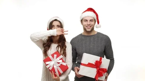 Slow-motion young couple in sweaters enjoy dancing with present celebrate for Stock Footage 84217623