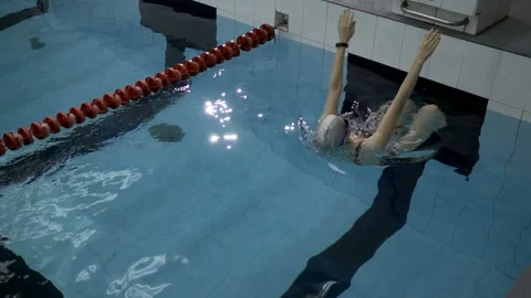 Slow motion of young female learning backstroke in swimming pool Stock-Footage 106416841