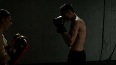 Slow motion of young fighters training in gym for kick boxing match using tha Stock Footage 77777515